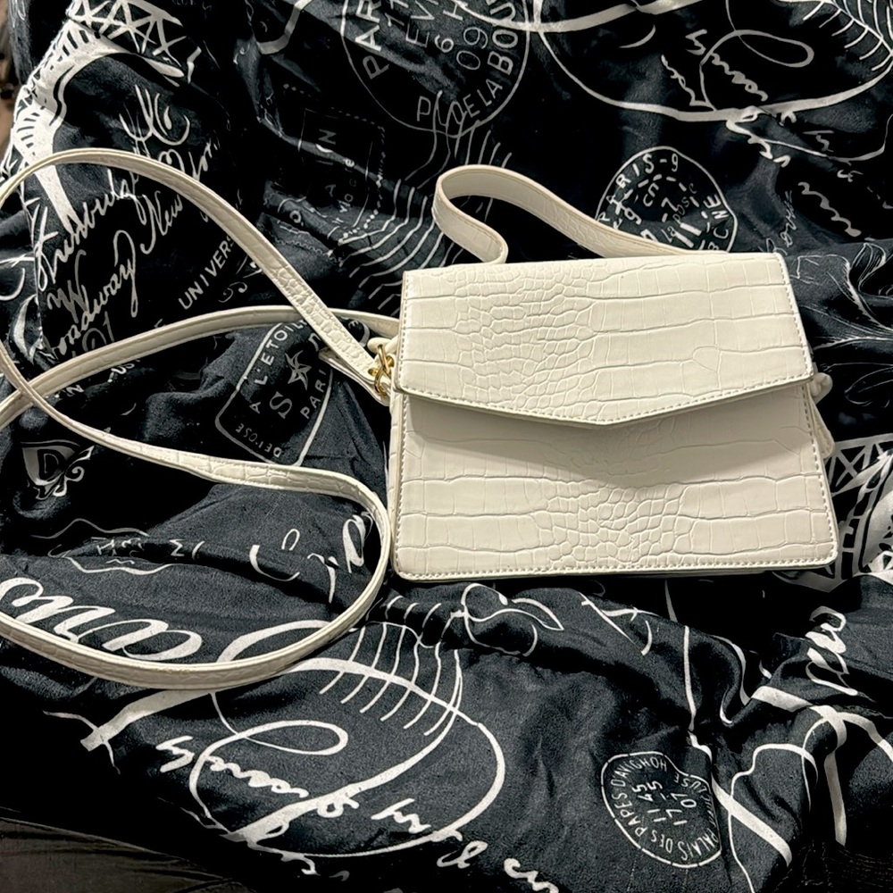 A mini Like dreams purse with a long and short handle